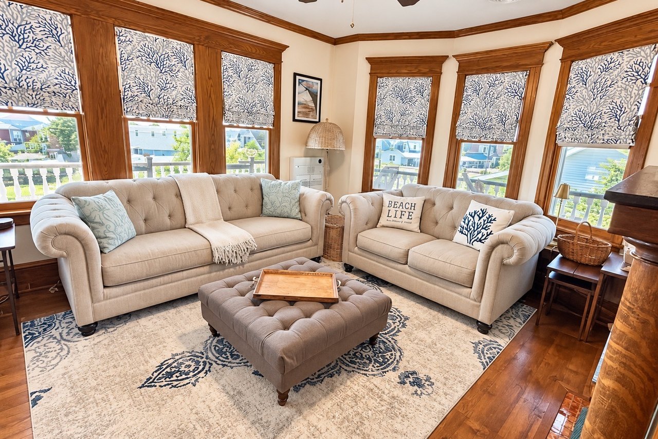 Living room with bay windows and tufted sofas