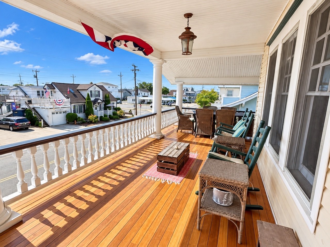 Wraparound porch with rocking chairs at Aster Shores